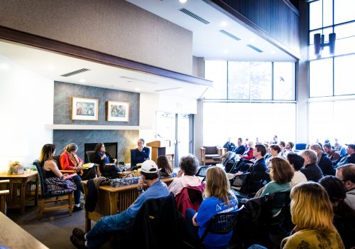 Authors sitting in the Laurel Forum in front of a crowd